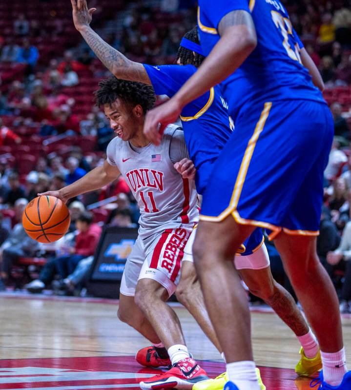 UNLV guard Dedan Thomas Jr. (11) battles in the lane against the San Jose State Spartans during ...