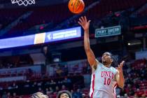 UNLV guard Jaden Henley (10) gets off a shot over Fresno State Bulldogs forward Elijah Price (3 ...