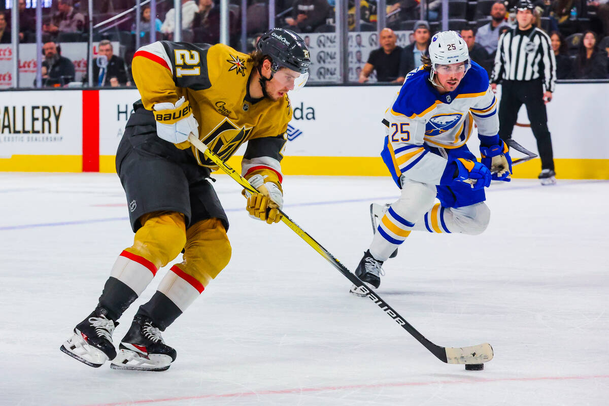 Golden Knights center Brett Howden (21) shuffles the puck during an NHL hockey game between the ...