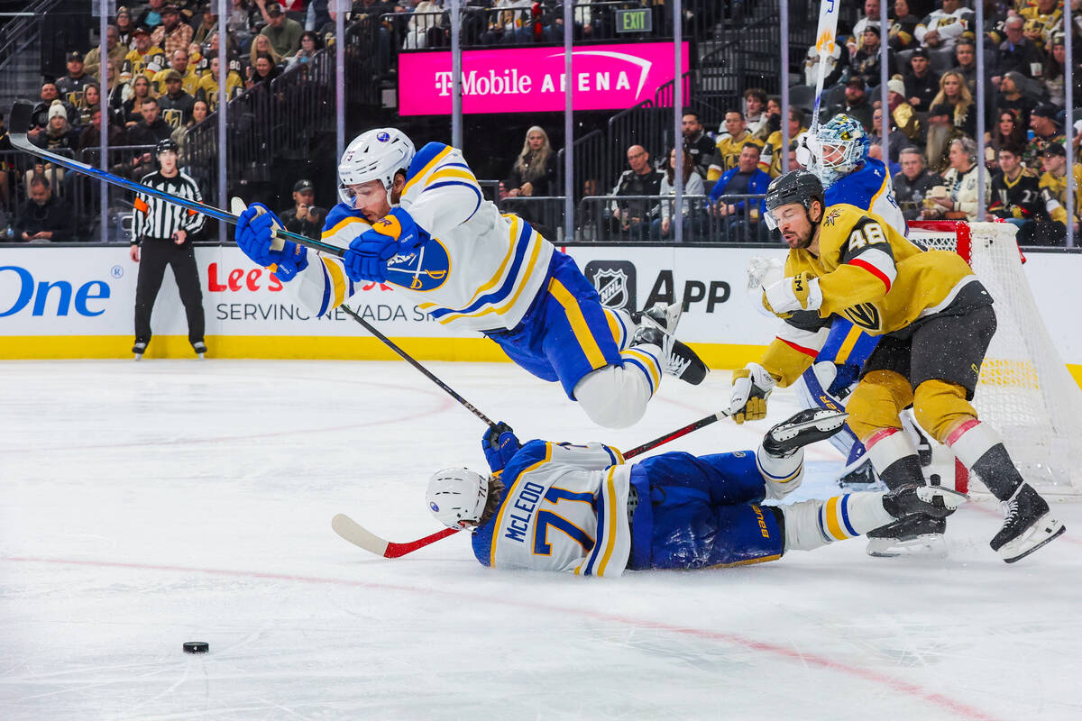 Buffalo Sabres defenseman Connor Clifton (75) leaps over Buffalo Sabres center Ryan McLeod (71) ...