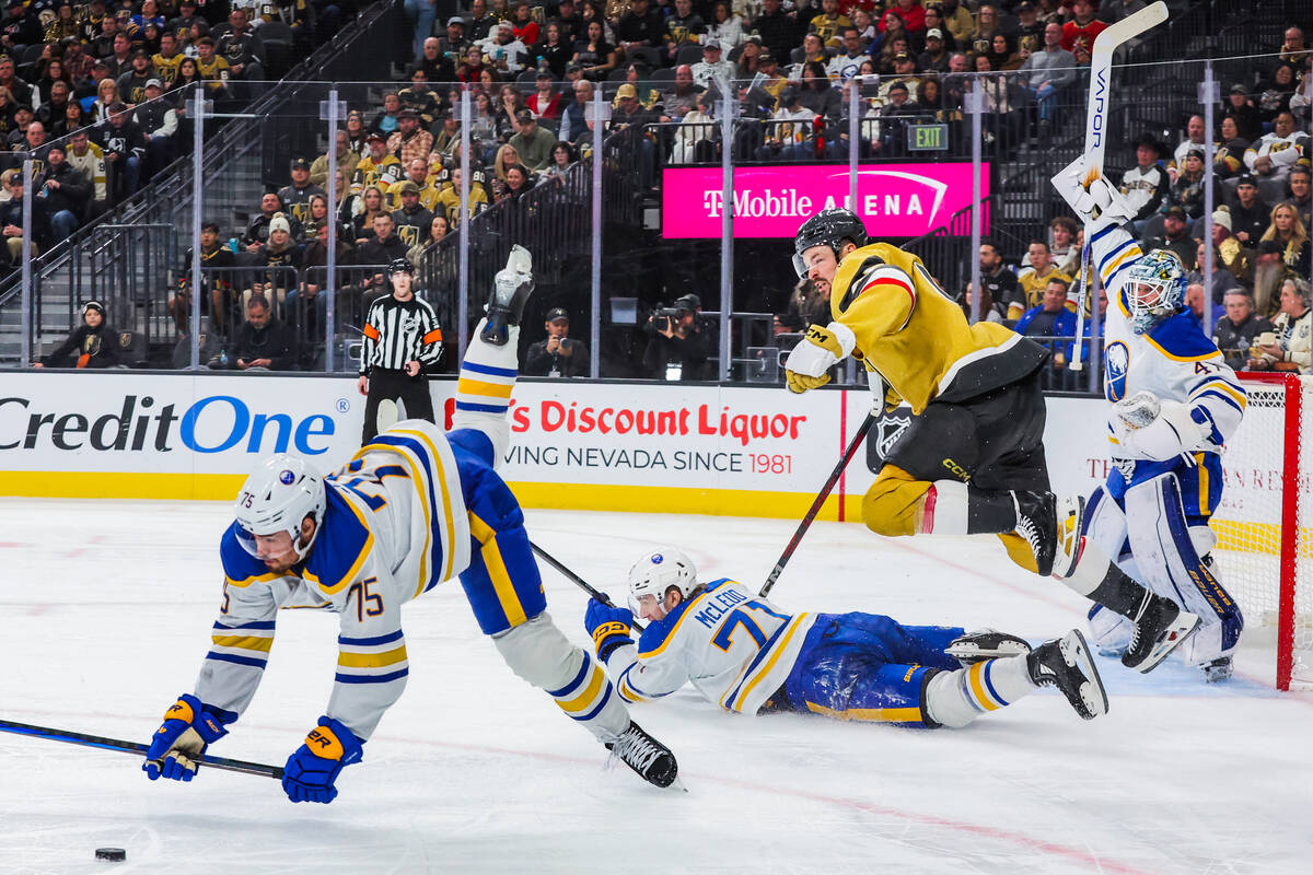 Buffalo Sabres defenseman Connor Clifton (75) lands on the ice as Golden Knights center Tomas H ...