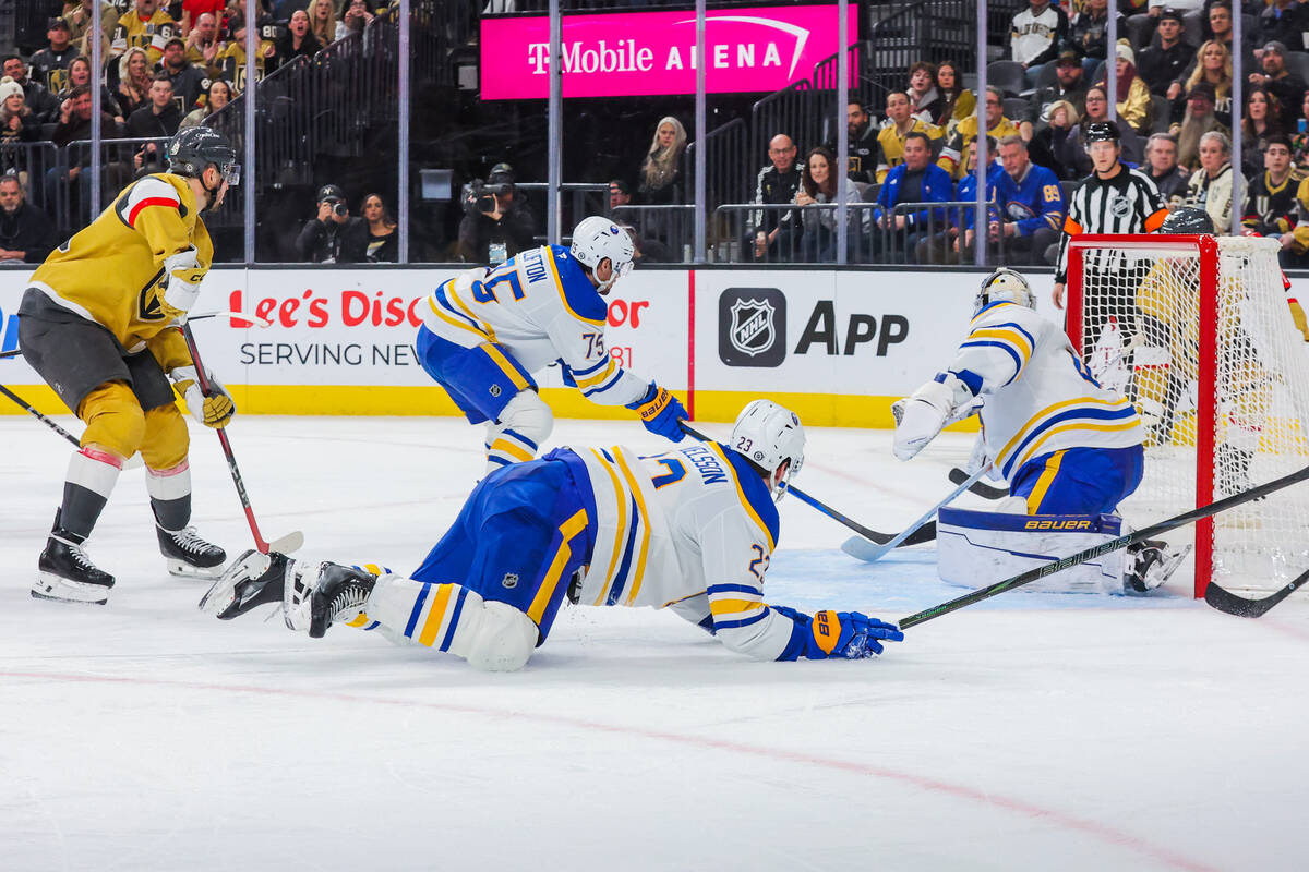 Buffalo Sabres defenseman Mattias Samuelsson (23) falls during an NHL hockey game between the G ...