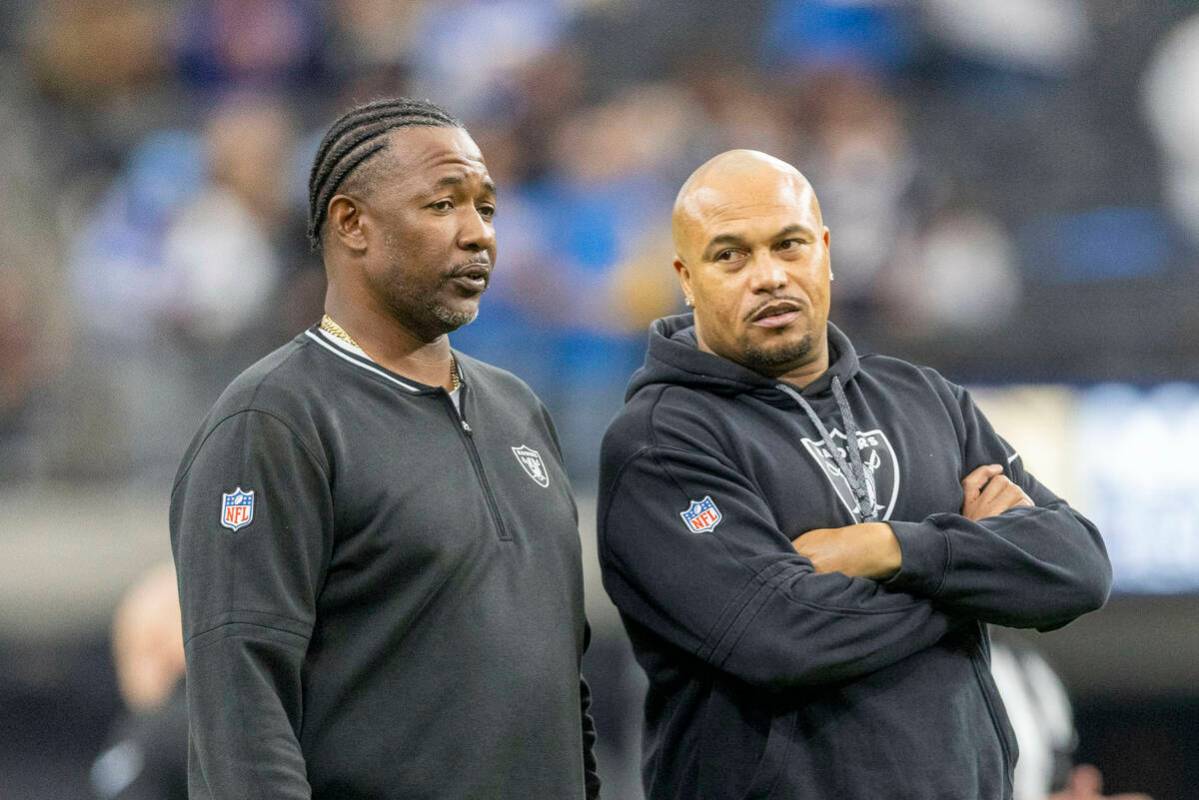 Raiders defensive coordinator Patrick Graham, left, speaks to head coach Antonio Pierce before ...