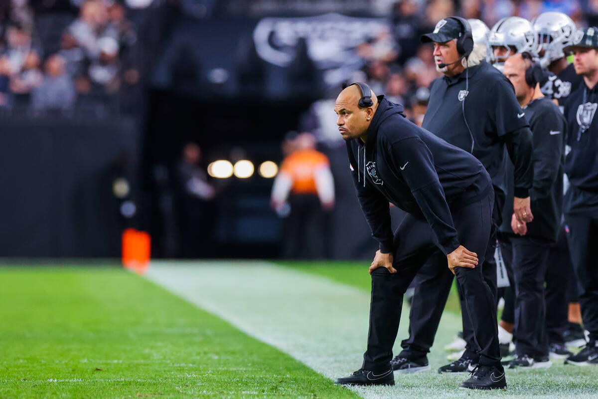 Raiders head coach Antonio Pierce watches game action during an NFL football game between the R ...