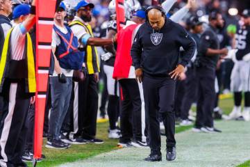 Raiders head coach Antonio Pierce walks the sidelines during an NFL football game between the R ...