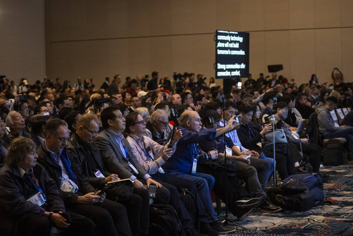 People watch and record the CES Tech Trends presentation on the first media day of the annual i ...