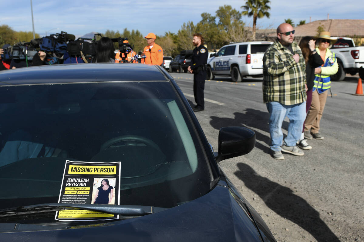 Corey and Jennifer Swanson are escorted past a missing person flyer for their daughter, Jennale ...