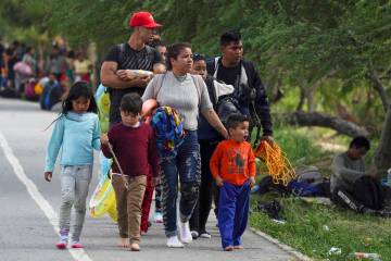 Migrants arrive to the Mexican side of the bank of the Rio Grande river in Matamoros, Mexico, T ...