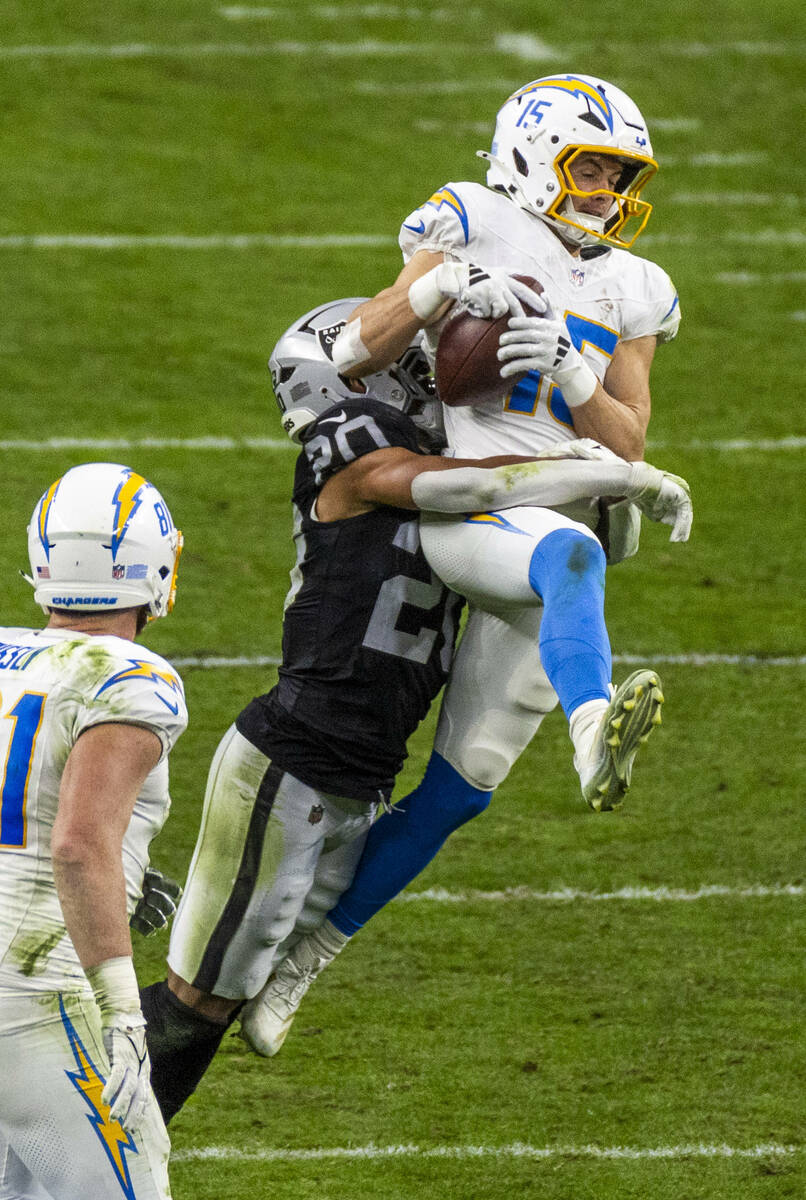 Los Angeles Chargers wide receiver Ladd McConkey (15) elevates to make a catch over Raiders saf ...