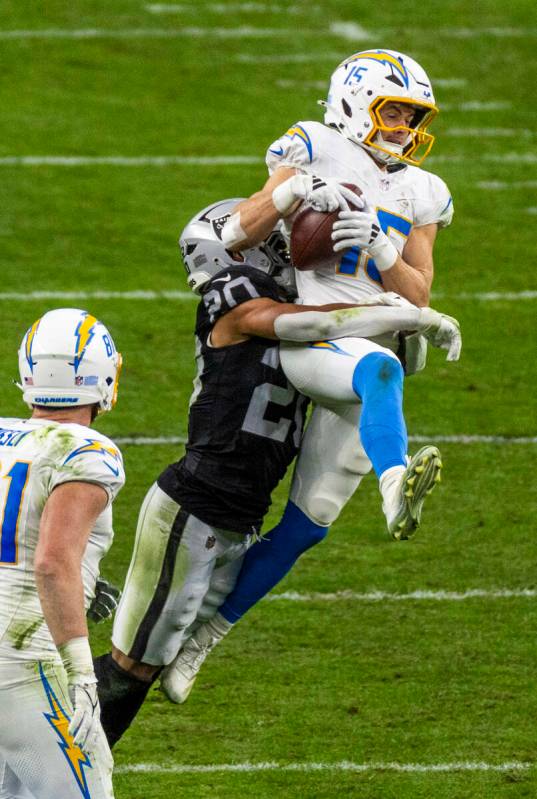 Los Angeles Chargers wide receiver Ladd McConkey (15) elevates to make a catch over Raiders saf ...