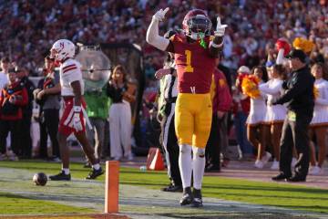 Southern California wide receiver Zachariah Branch, right, celebrates after coming up a few yar ...