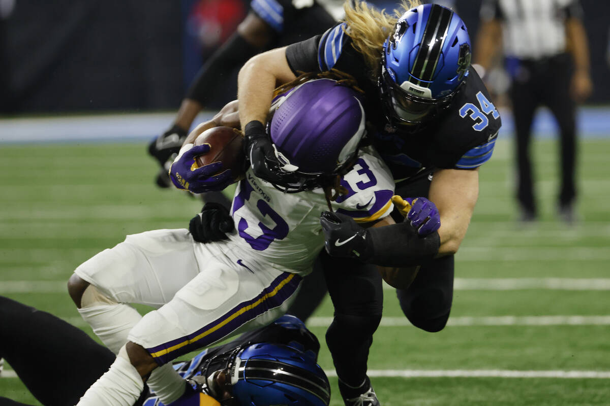 Minnesota Vikings cornerback Fabian Moreau (23) is tackled by Detroit Lions defensive end Za'Da ...