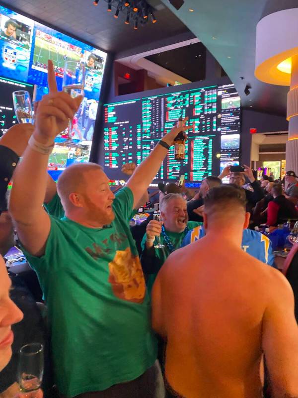 Carson Williams, left, cheers with the rest of team Meatball Brothers after winning a piece of ...