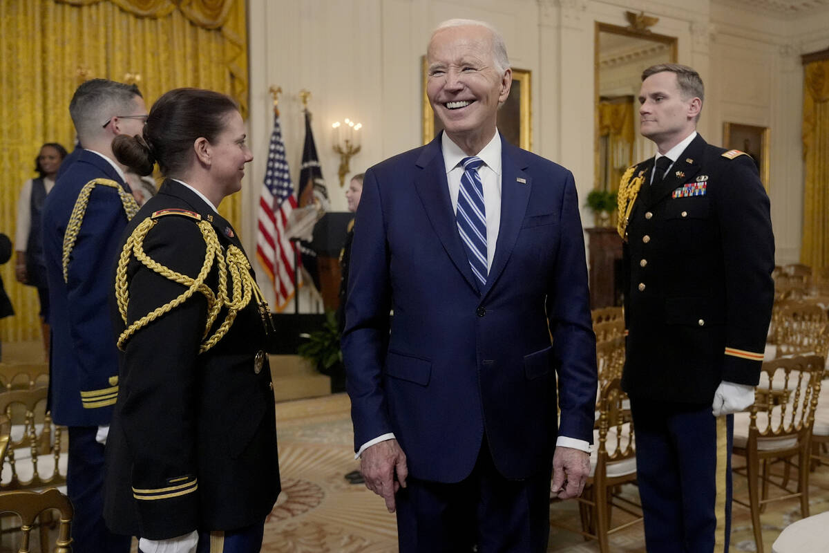 President Joe Biden departs the East Room of the White House after signing the Social Security ...