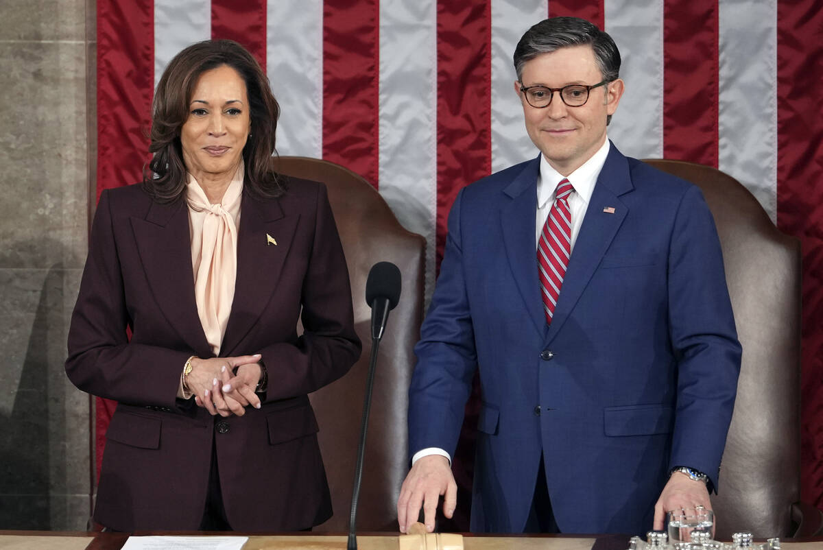 Vice President Kamala Harris stands with House Speaker Mike Johnson, R-La., as a joint session ...