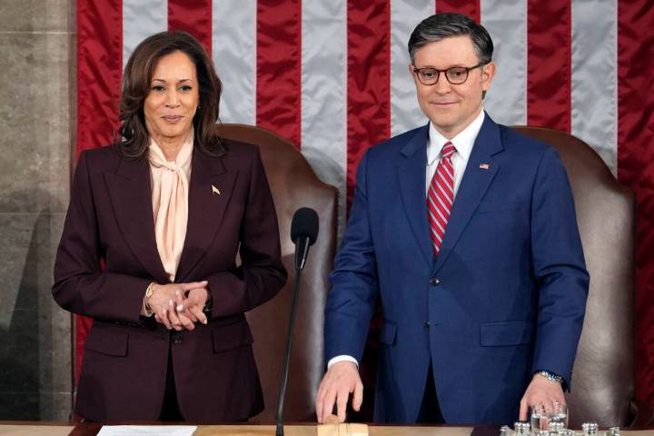 Vice President Kamala Harris stands with House Speaker Mike Johnson, R-La., as a joint session ...