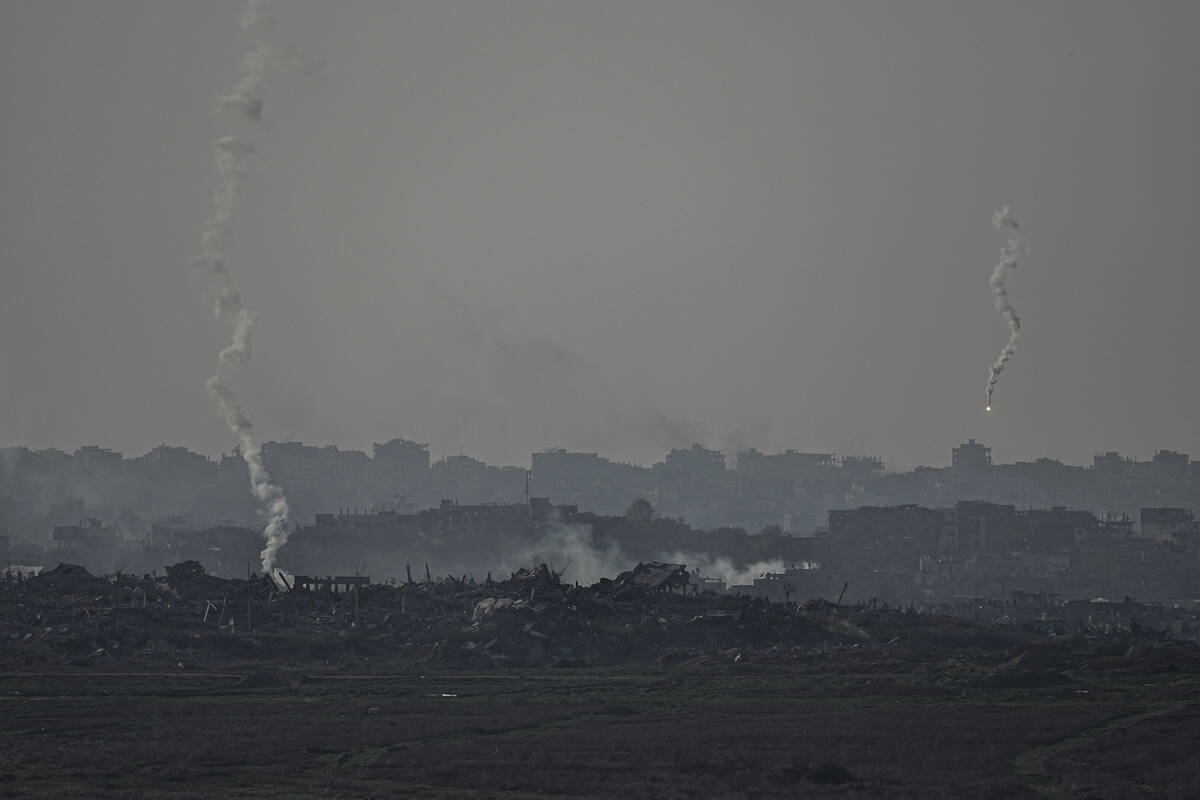 An Israeli army flare is seen over the Gaza Strip, as seen from Sderot, southern Israel, Monday ...