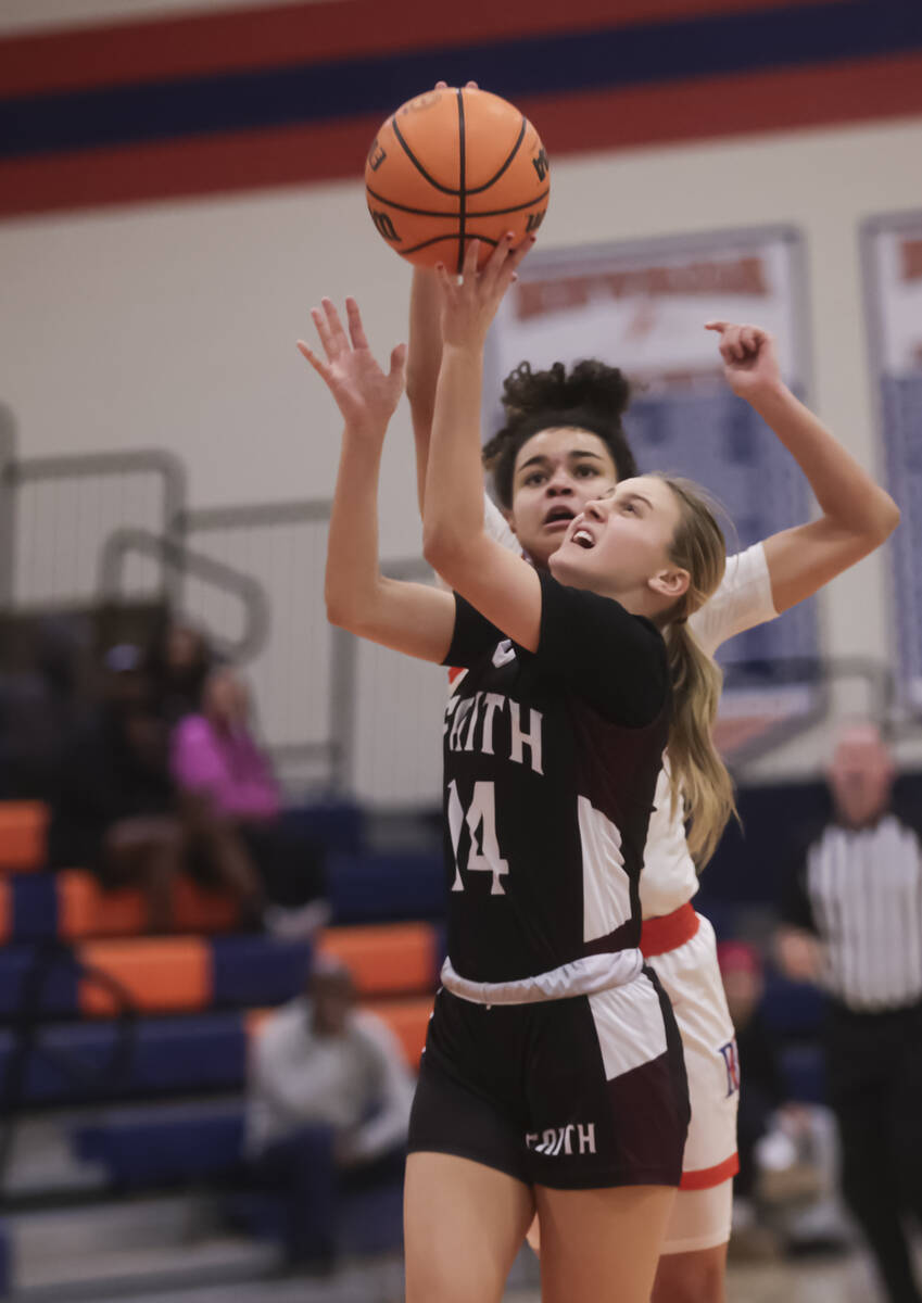 Faith Lutheran's Kloe Abdalla (14) shoots under pressure from Bishop Gorman's Aaliah Spaight (1 ...