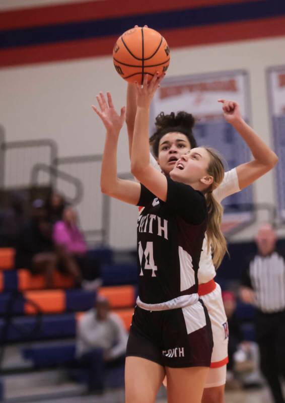 Faith Lutheran's Kloe Abdalla (14) shoots under pressure from Bishop Gorman's Aaliah Spaight (1 ...