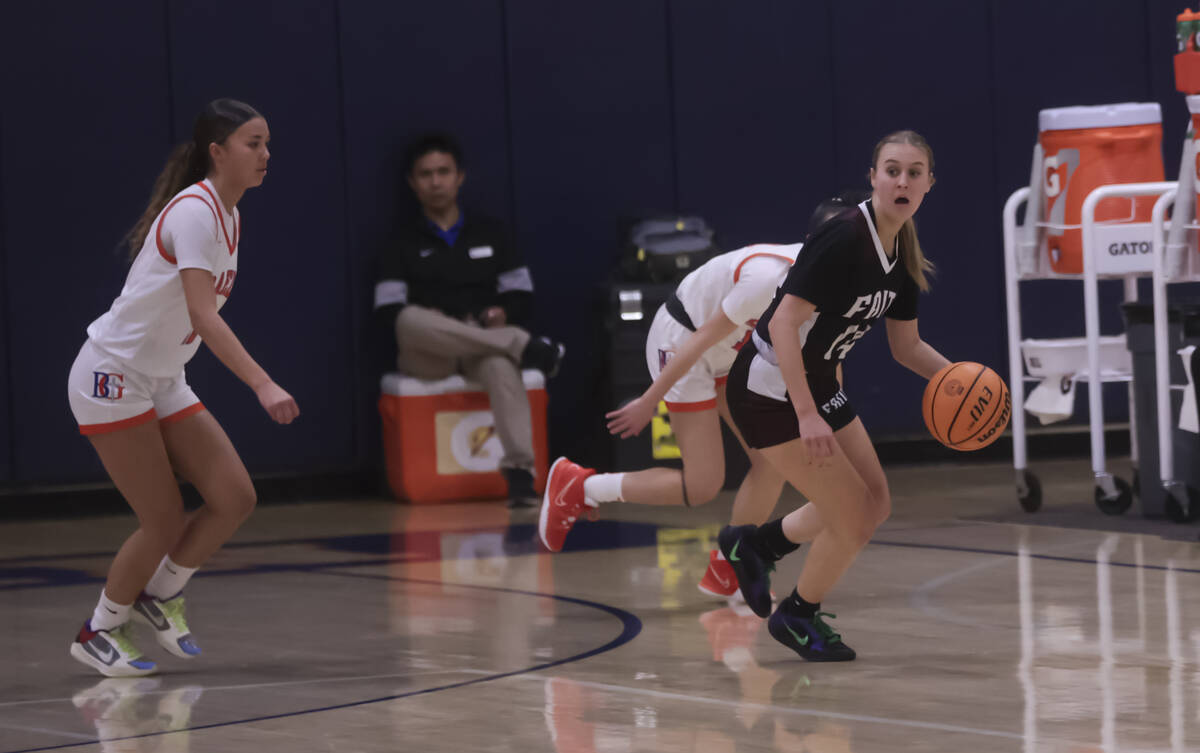 Faith Lutheran's Kloe Abdalla (14) looks to pass the ball under pressure from Bishop Gorman dur ...