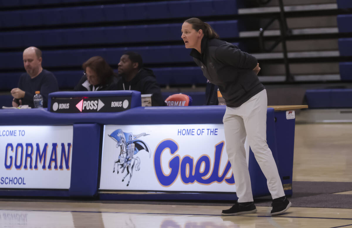 Faith Lutheran head coach Jennifer Karner talks to her team during a high school basketball gam ...