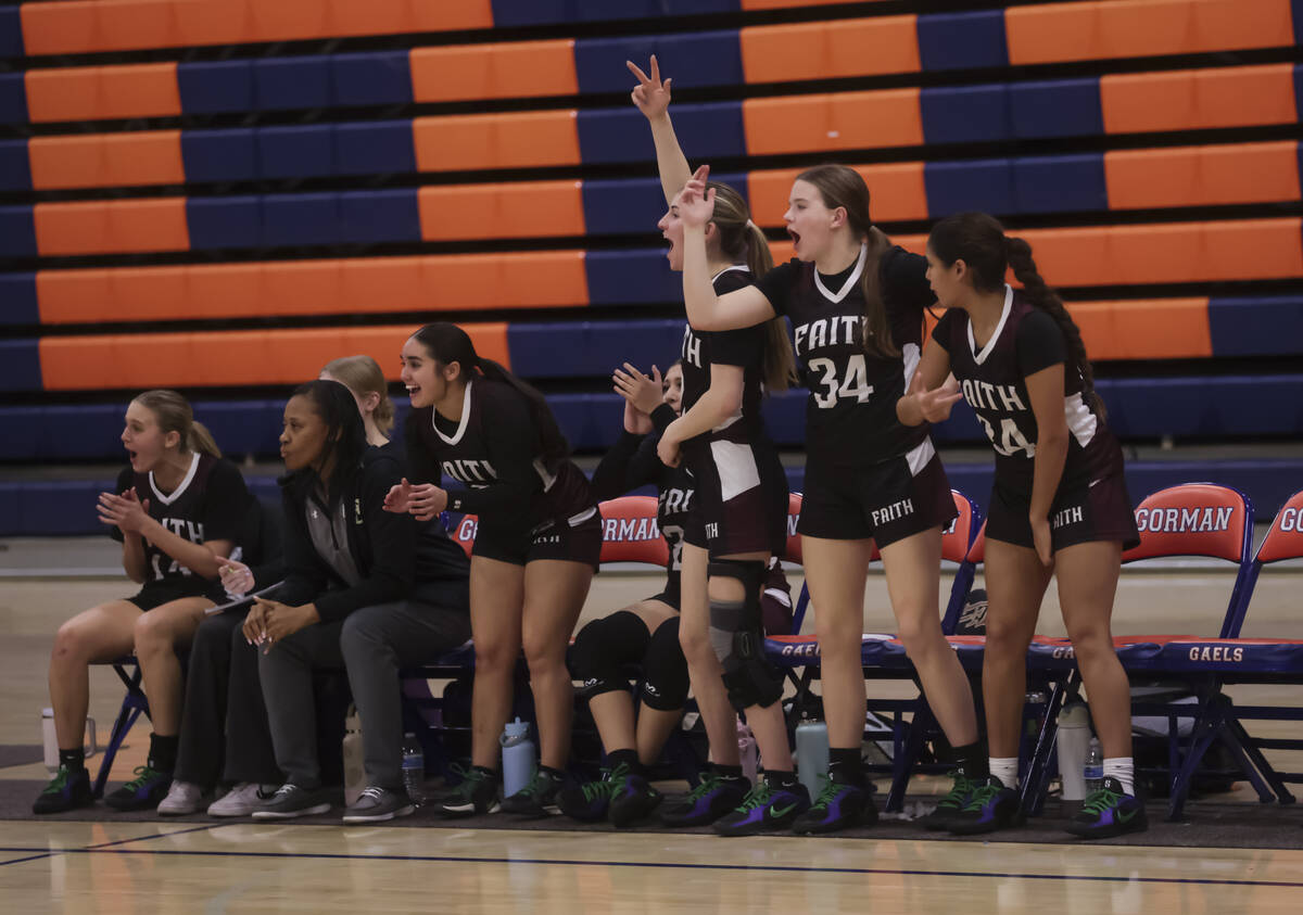 Faith Lutheran players celebrate a play during a high school basketball game at Bishop Gorman H ...