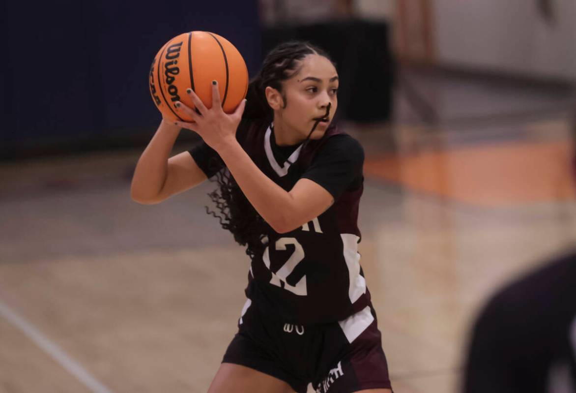 Faith Lutheran's Aliyah Maese (12) looks to pass during a high school basketball game at Bishop ...