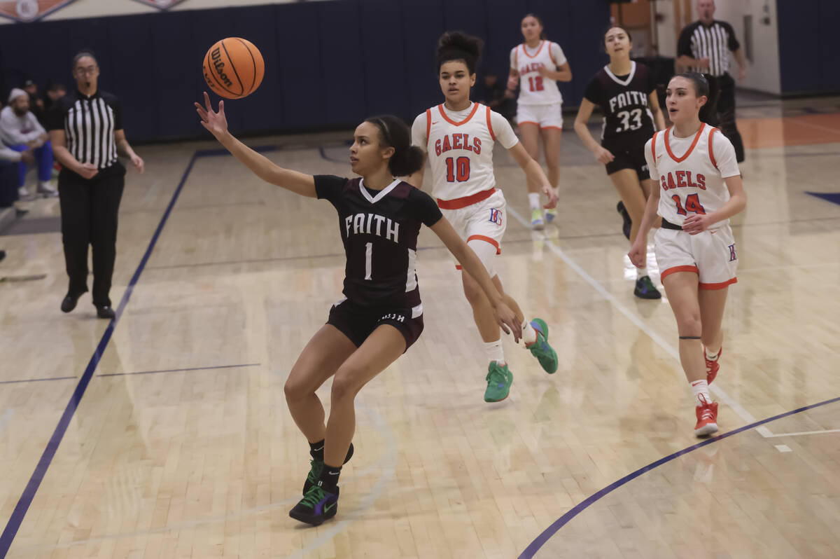 Faith Lutheran's Jasmyn Jackson (1) grabs a loose ball during a high school basketball game at ...