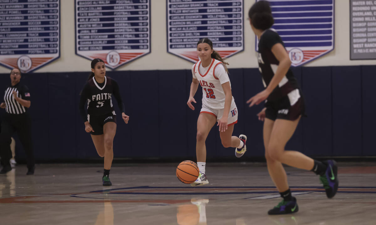 Bishop Gorman's Addysen Carr (12) brings the ball up court as Faith Lutheran's guard Caylyn Yo ...