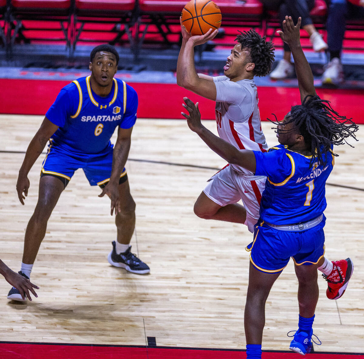 UNLV guard Dedan Thomas Jr. (11) elevates to score over San Jose State Spartans guard Will McCl ...