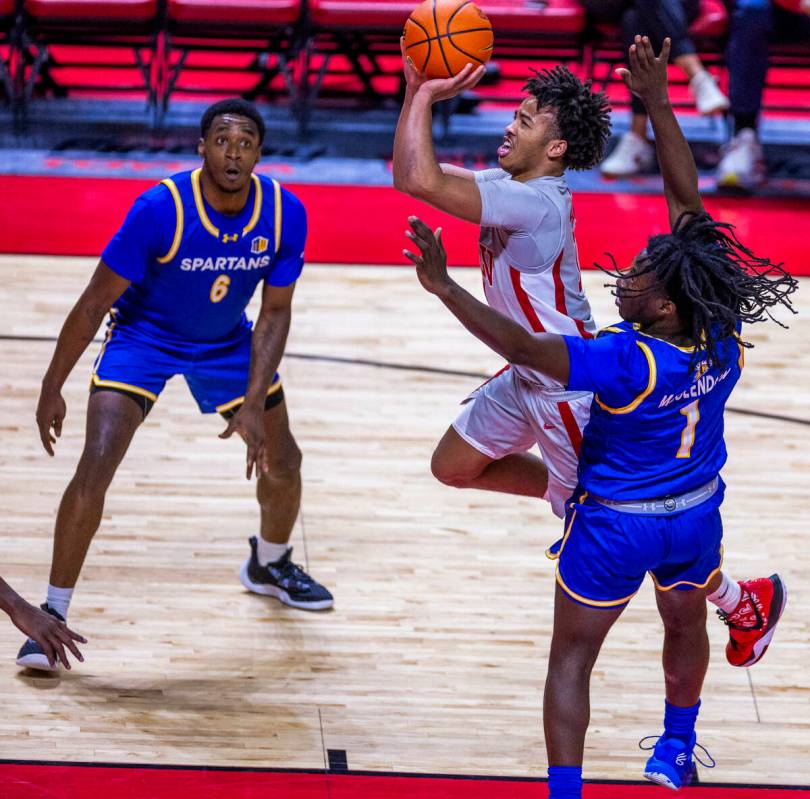 UNLV guard Dedan Thomas Jr. (11) elevates to score over San Jose State Spartans guard Will McCl ...