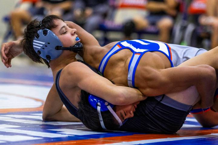 SLAM's William Bonwell, left, takes control over Bishop Gorman's Connor Johns during their 112 ...