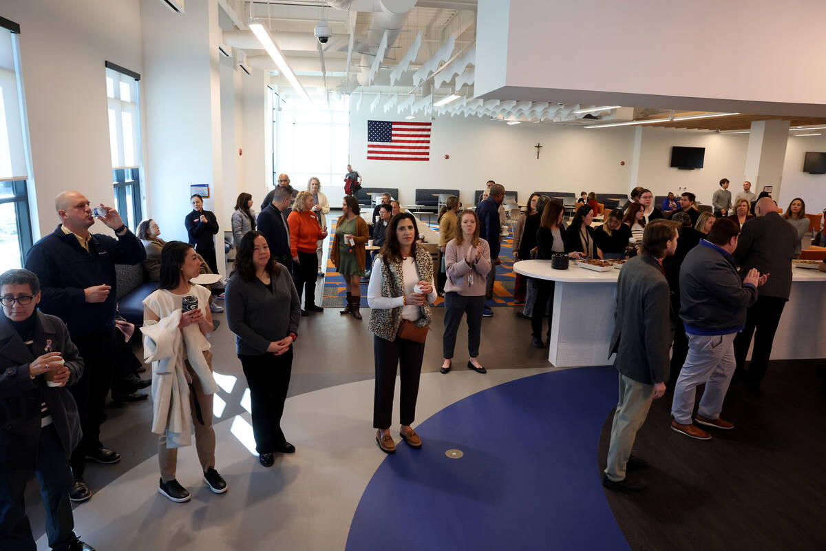 Guests watch a blessing for the new Gaughan Family Student Union at Bishop Gorman High School i ...