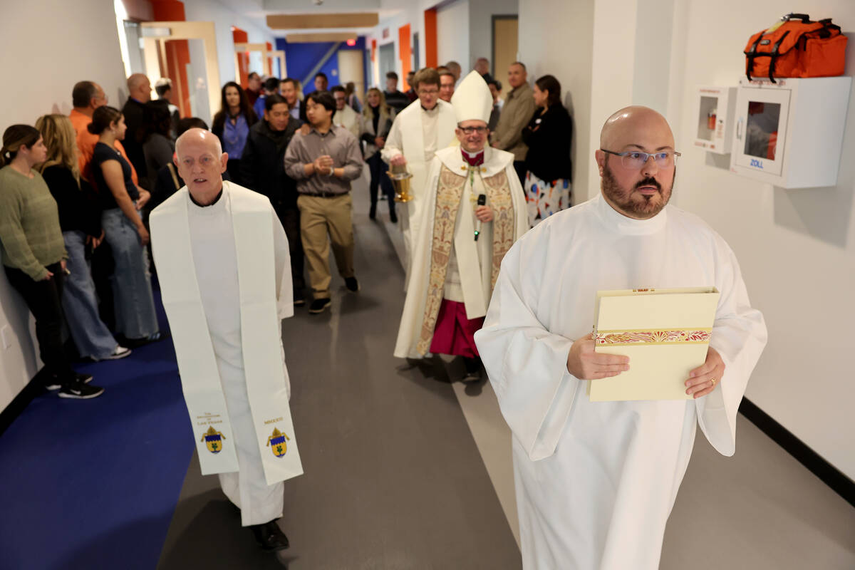 Clergy and guests walk through the new Gaughan Family Student Union at Bishop Gorman High Schoo ...