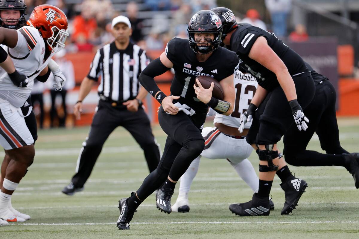 Northern Illinois quarterback Josh Holst (15) rushes against Bowling Green during an NCAA footb ...