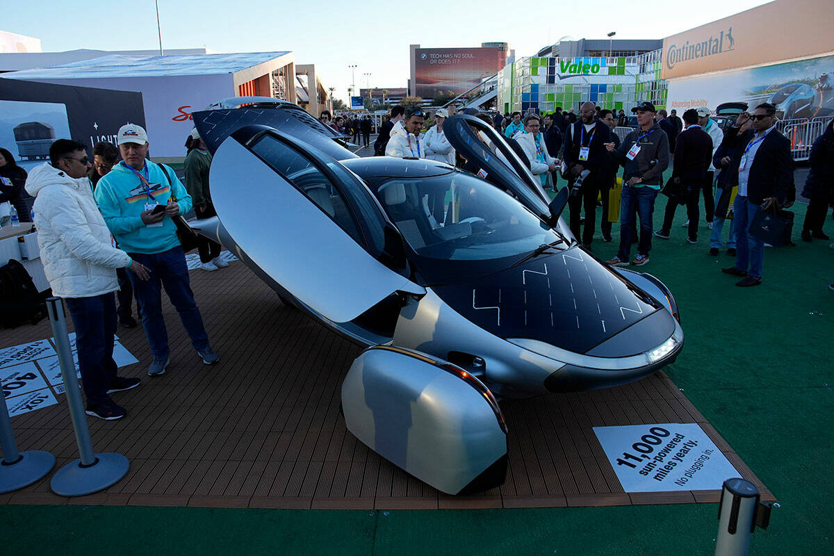 People look at a prototype solar electric vehicle by Aptera Motors during the CES tech show Tue ...