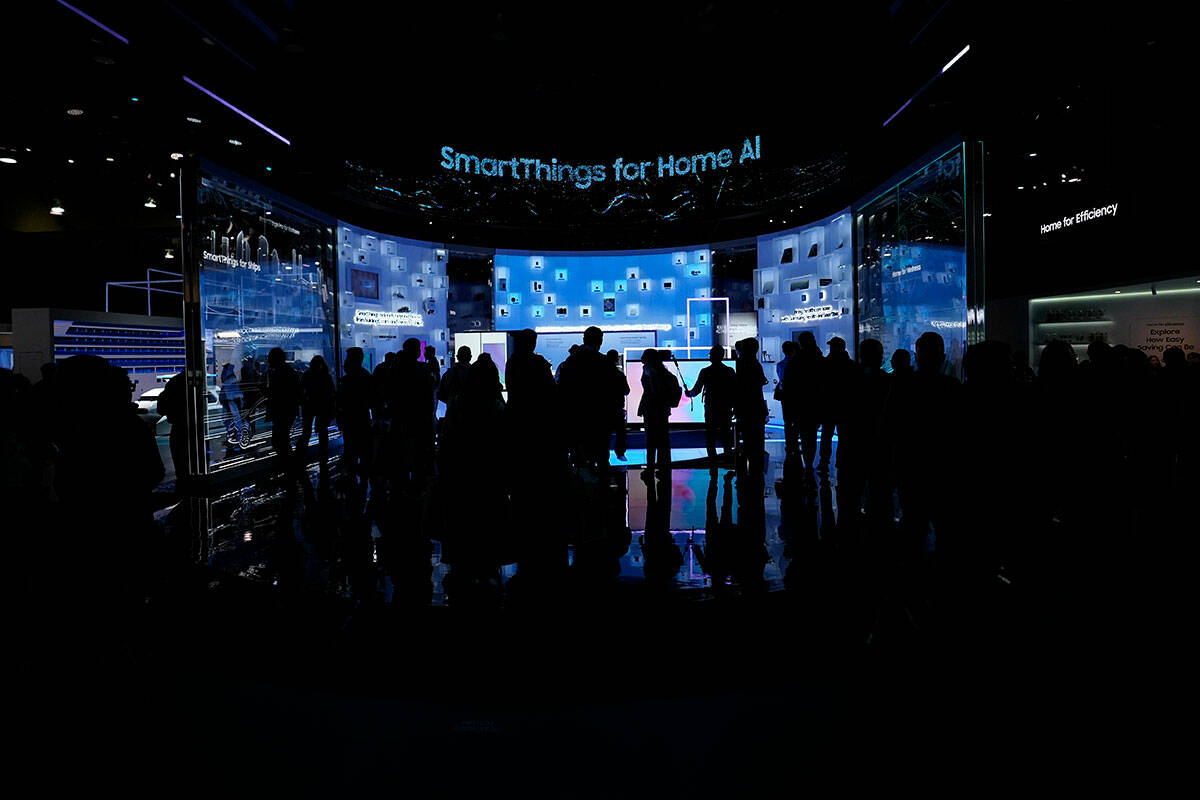 People look at a display of Samsung screens and products at the CES tech show Tuesday, Jan. 7, ...