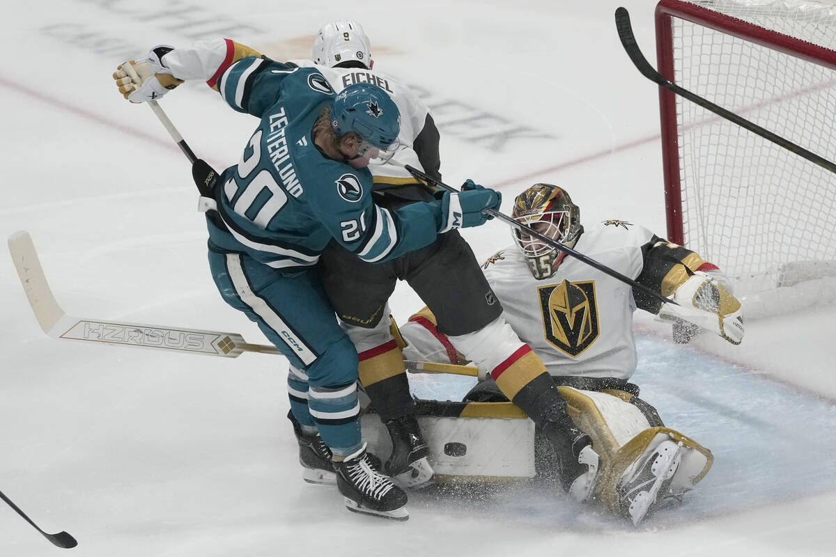 San Jose Sharks left wing Fabian Zetterlund (20) looks for the puck next to Vegas Golden Knight ...