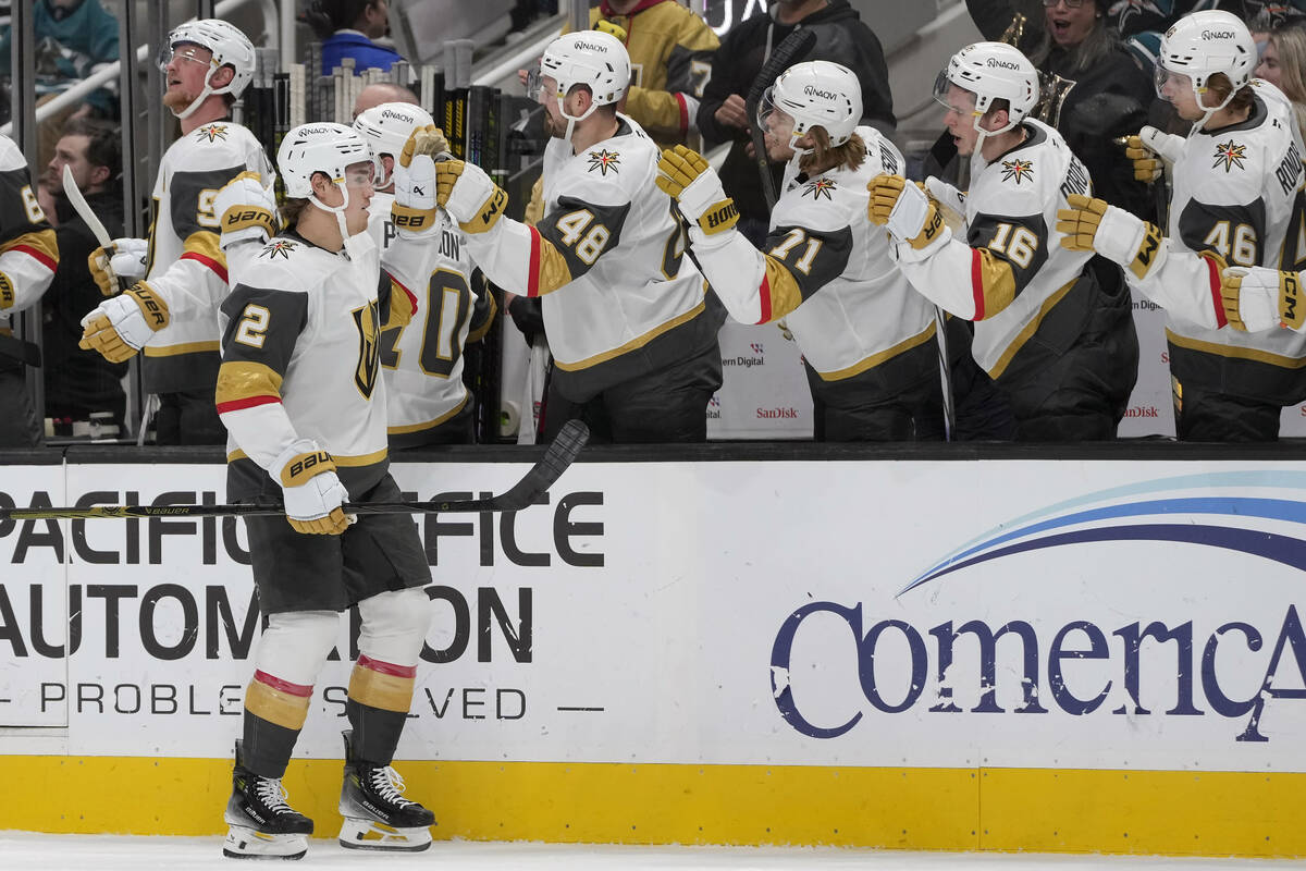 Vegas Golden Knights defenseman Zach Whitecloud (2) is congratulated by teammates after scoring ...