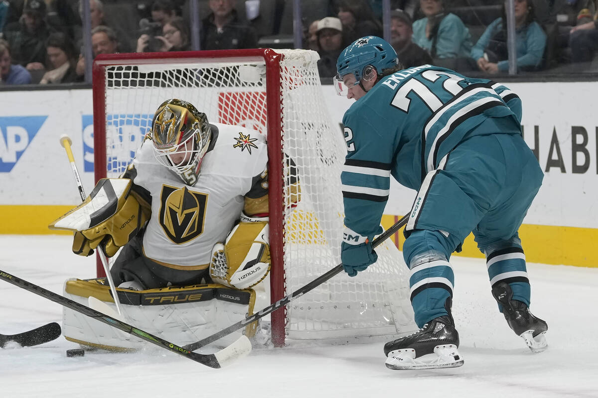 Vegas Golden Knights goaltender Ilya Samsonov, left, defends against a shot by San Jose Sharks ...