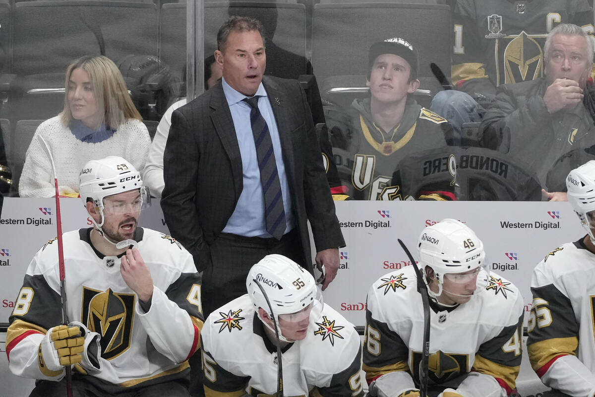 Vegas Golden Knights head coach Bruce Cassidy, standing, reacts from behind players on the benc ...