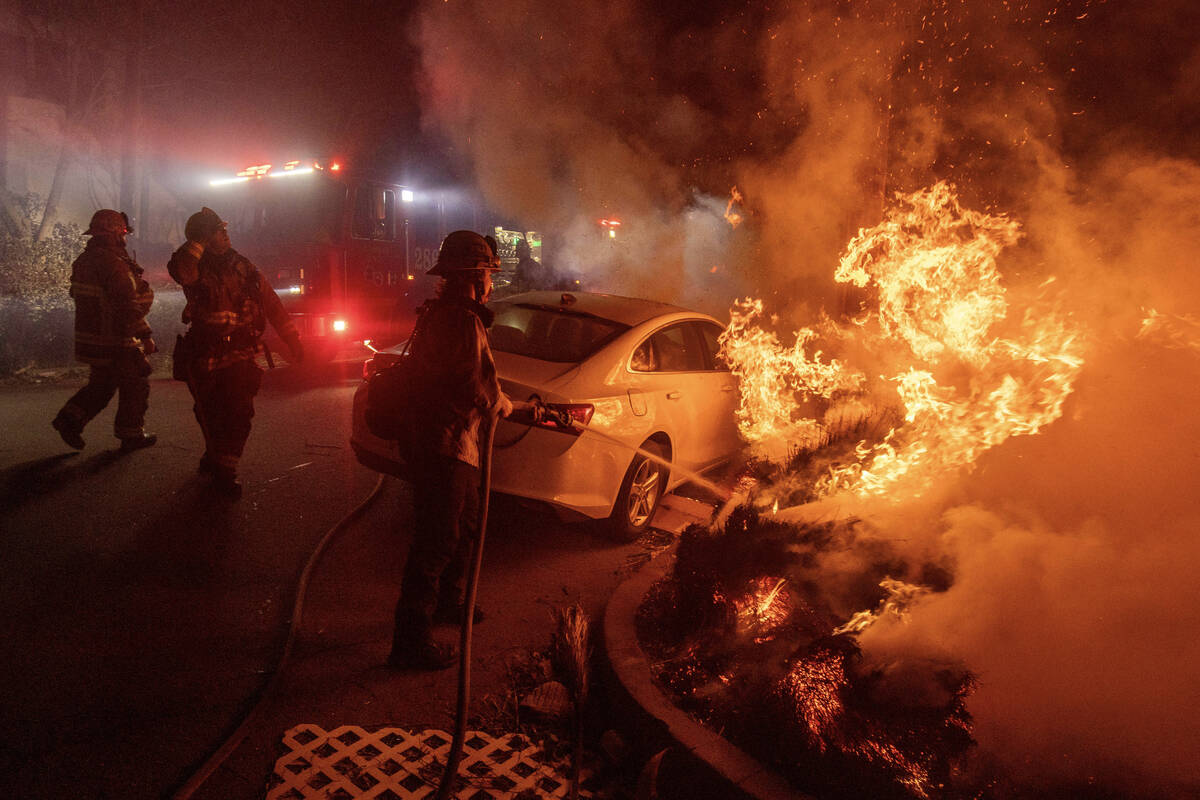 Firefighters battle the Eaton Fire Tuesday, Jan. 7, 2025 in Altadena, Calif. (AP Photo/Ethan Swope)