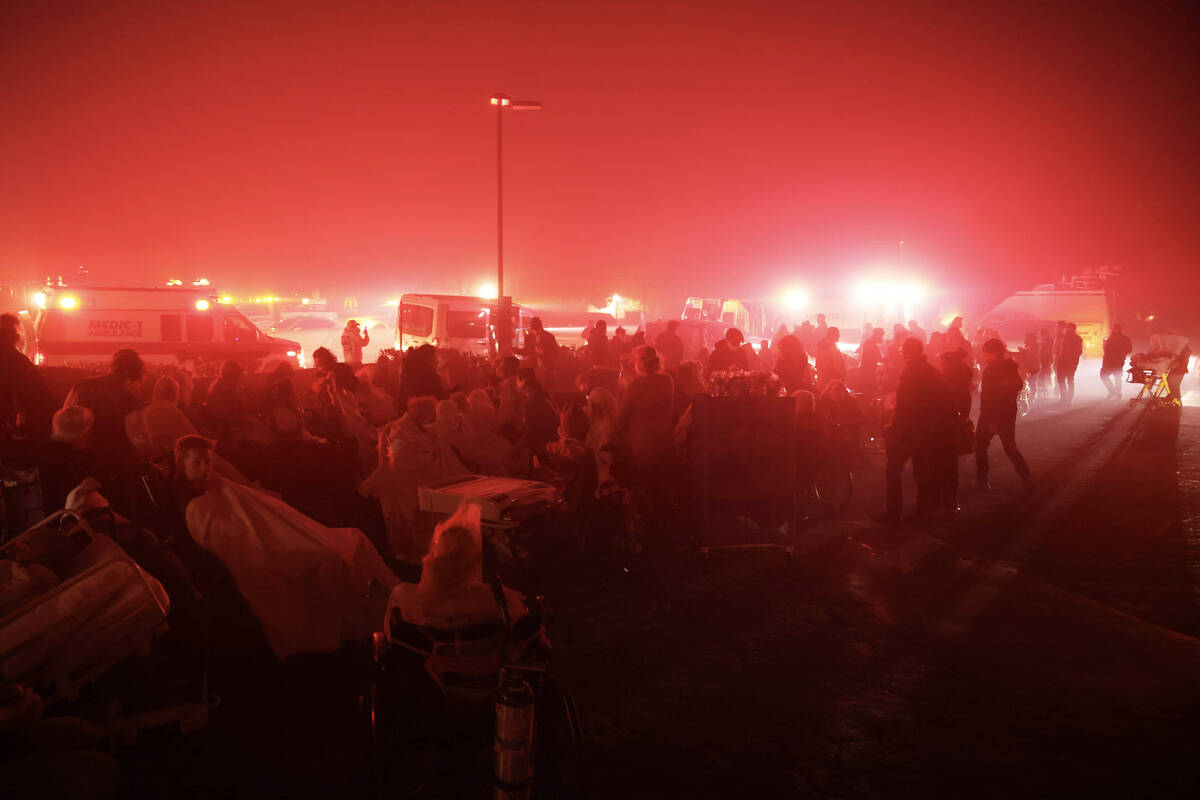 Residents of a senior center are evacuated as the Eaton Fire approaches Tuesday, Jan. 7, 2025, ...