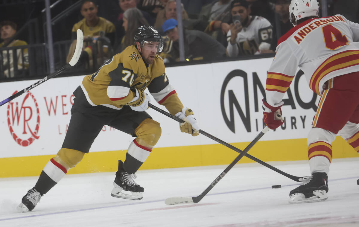 Golden Knights left wing Tanner Pearson (70) skates with the puck under pressure from Calgary F ...