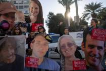 Relatives and supporters of Israeli hostages held by Hamas in Gaza hold photos of their loved o ...