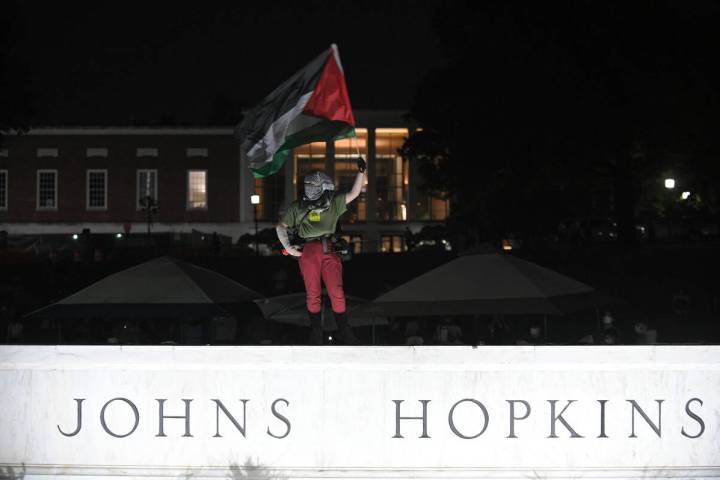 Protesters gather at the Johns Hopkins University’s beach and prepare to spend the night ...