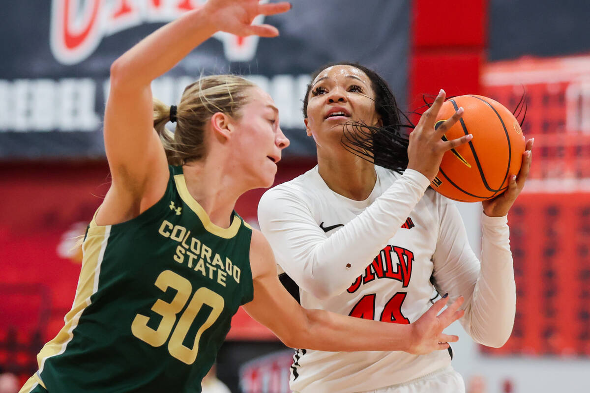 Lady Rebels forward Alyssa Brown (44) attempts a basket as Colorado State Rams guard Hannah Ron ...