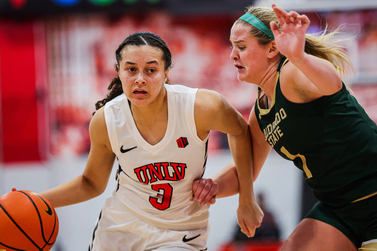 Lady Rebels guard Kiara Jackson (3) dribbles the ball as Colorado State Rams guard Kloe Froebe ...