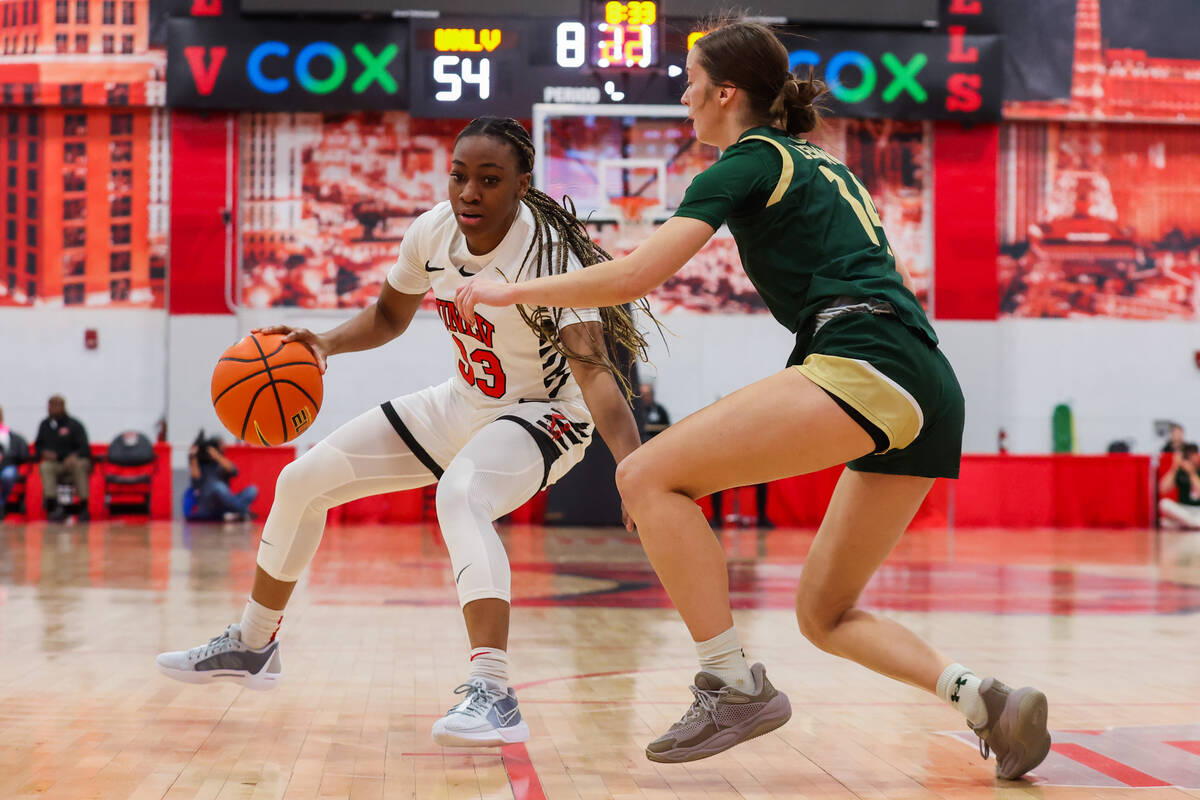 Lady Rebels guard Amarachi Kimpson (33) dribbles the ball as Colorado State Rams guard Marta Le ...