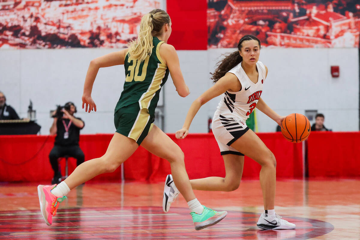 Lady Rebels guard Kiara Jackson (3) dribbles the ball as Colorado State Rams guard Hannah Ronsi ...